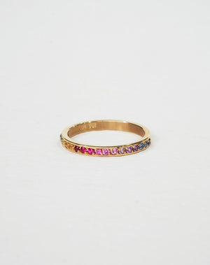 A 9ct yellow gold eternity band ring pave set halfway with colorful rainbow sapphires.
