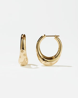 A pair of large hoop earrings made of gold, designed to resemble strawberries.