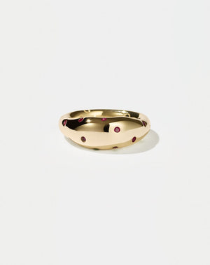 A  gold ring with round brilliant rubies set in Swiss settings