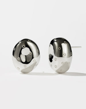 A pair of sterling silver earrings designed in the shape of abstract strawberries with seeds resembling texture on a white background.