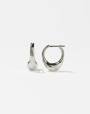 A pair of sterling silver hoop earrings with a small abstract strawberry design, featuring circles along the hoop to represent strawberry seeds.