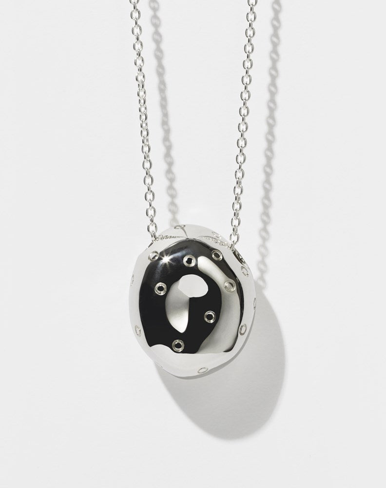 A sterling silver pendant in the shape of an abstract strawberry 