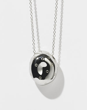 A sterling silver pendant in the shape of an abstract strawberry 