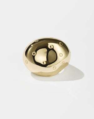 A gold abstract strawberry-shaped ring with visible seed-like details on the top surface.