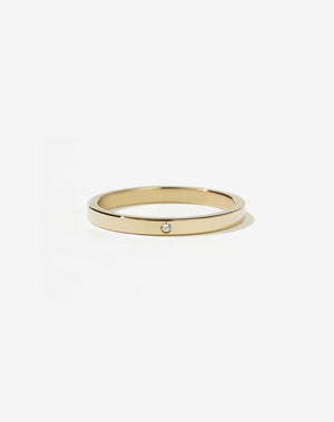 A minimalist gold band with a single stone set