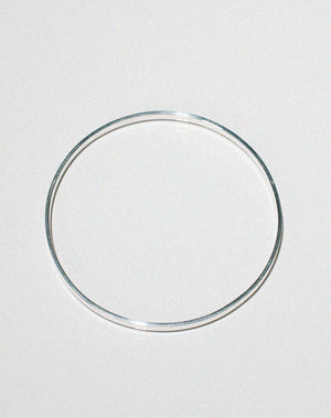 Silver flat bangle shown side on.