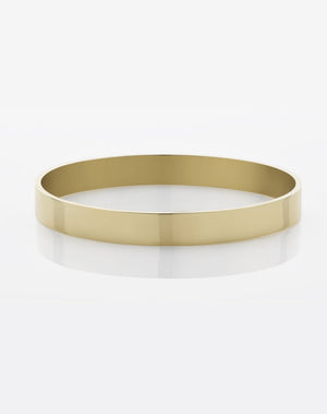 A solid 8mm wide smooth bangle in yellow gold.