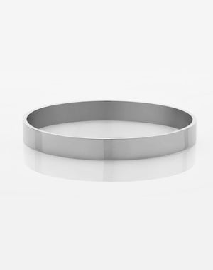 A sterling silver flat bangle bracelet with a smooth finish, 8mm in width, on a white background.