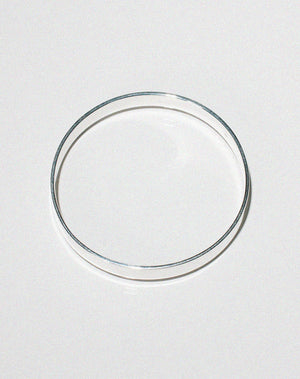 Flat silver bangle, shown from the side.