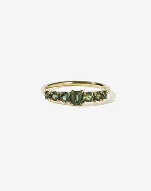 Meadowlark Jewellery’s beautiful Amelie Engagement Ring in 14ct Yellow Gold, claw set with emerald cut and round brilliant cut green sapphires atop a fine round band. Fully traceable and ethically sourced blue and green sapphires from Queensland, Australia. A low set, petite seven stone engagement ring this Ceremonial design made to order in New Zealand.