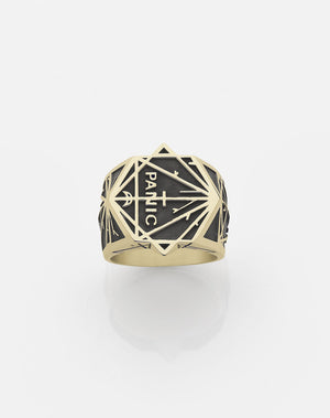 A heavy weighted gold ring with an oxidized finish and a geometric pattern design, featuring the text 'Panic' by Andrew Mcleod.