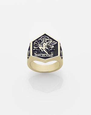 A heavy-duty gold ring with an oxidized finish featuring a black and white artwork design in the center.