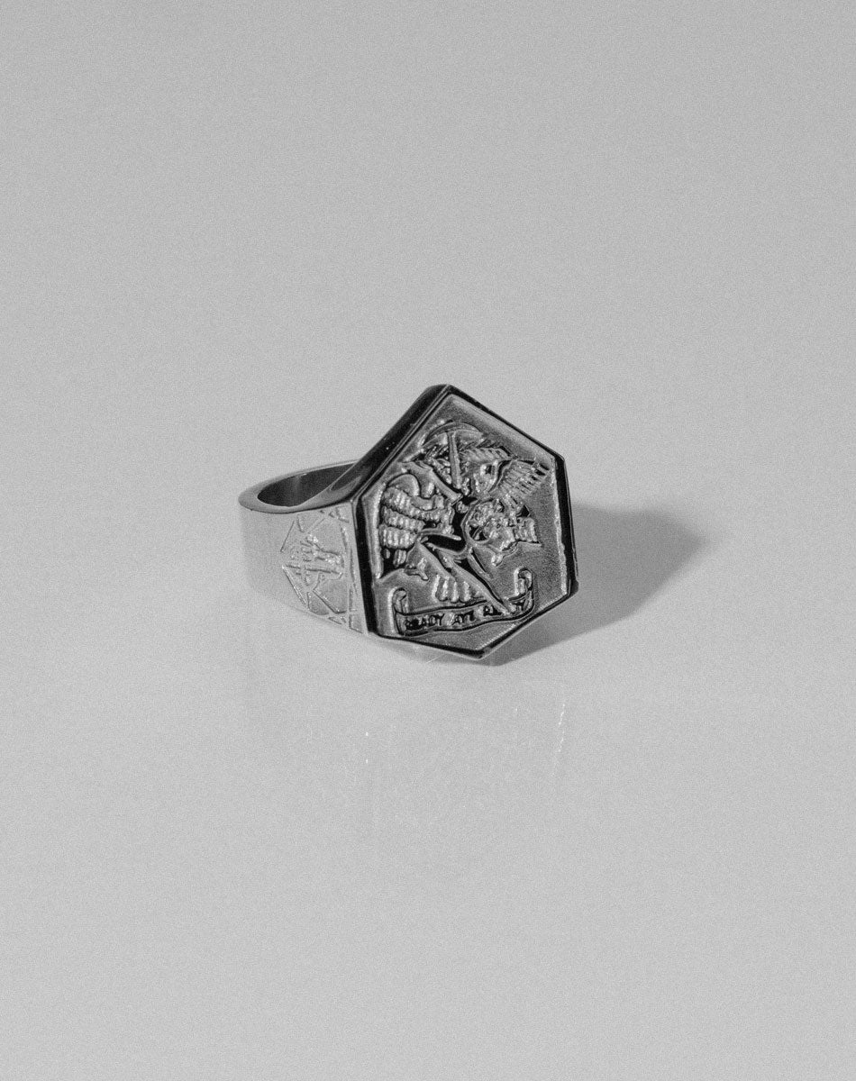 A heavy weighted sterling silver ring with a collage of artworks, designed in collaboration with NZ artist Andrew McLeod.