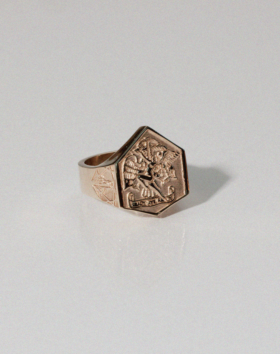 A heavy weighted gold ring with a collage of artworks, designed in collaboration with NZ artist Andrew McLeod.