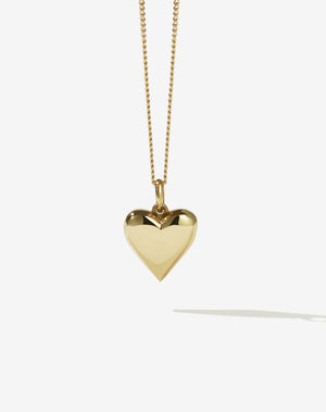 A solid gold heart-shaped pendant necklace on a fine chain.