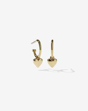A pair of 9ct solid gold hoop earrings with a small heart charm attached to each hoop.