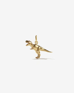A small gold charm in the shape of a dinosaur