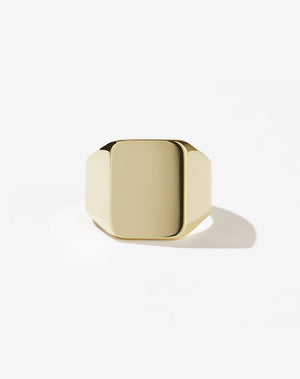 An oversized 9ct yellow gold signet ring with a flat rectangular platform for engraving.