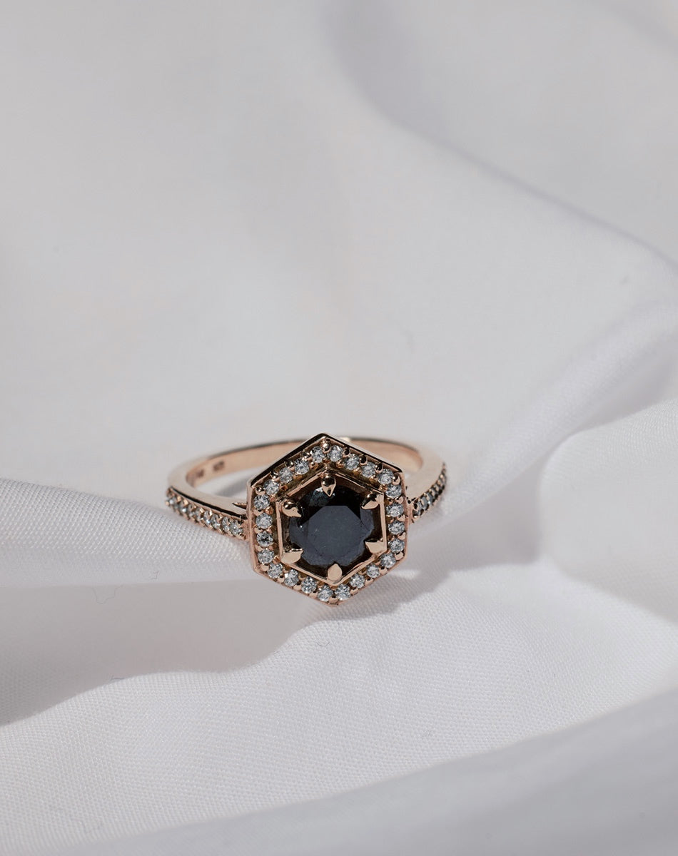 Black and white diamond engagement ring with centre stone and a hexagon halo