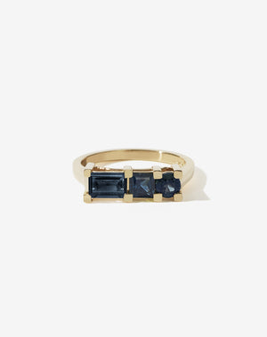 Meadowlark Jewellery’s architecture inspired 1.1ct Hilma Engagement Ring in 9ct Yellow Gold, claw set with a round brilliant cut, princess cut and baguette cut blue sapphire. Atop a fine square band. Fully traceable and ethically sourced blue and green sapphires from Queensland, Australia. A bold and alternative Ceremonial design made to order in New Zealand. Pair with our modern Stella Ring.