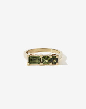 Meadowlark Jewellery’s architecture inspired 1.1ct Hilma Engagement Ring in 9ct Yellow Gold, claw set with a round brilliant cut, princess cut and baguette cut green sapphire. Atop a fine square band. Fully traceable and ethically sourced blue and green sapphires from Queensland, Australia. A bold and alternative Ceremonial design made to order in New Zealand. Pair with our modern Stella Ring.