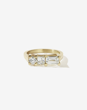 Meadowlark Jewellery’s architecture inspired 1.1ct Hilma Engagement Ring in 9ct Yellow Gold, claw set with a round brilliant cut, princess cut and baguette cut white diamond. Atop a fine square band. A bold and alternative Ceremonial design made to order in New Zealand. Pair with our modern Stella Ring.