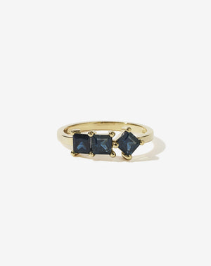 Meadowlark Jewellery’s modern Imogen Engagement Ring in 14ct Yellow Gold, claw set with three princess cut blue sapphires. Atop a fine square band. Fully traceable and ethically sourced blue and green sapphires from Queensland, Australia. A graphic 3 stone engagement ring, inspired by art and architecture, this Ceremonial design is made to order in New Zealand.