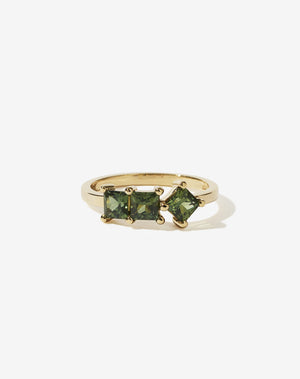 Meadowlark Jewellery’s modern Imogen Engagement Ring in 18ct Yellow Gold, claw set with three princess cut green sapphires. Atop a fine square band. Fully traceable and ethically sourced blue and green sapphires from Queensland, Australia. A graphic 3 stone engagement ring, inspired by art and architecture, this Ceremonial design is made to order in New Zealand.