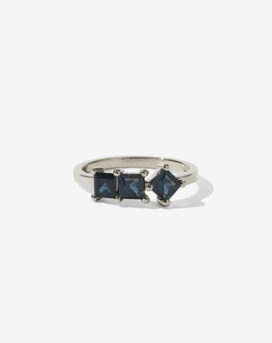 Sapphire: Meadowlark Jewellery’s modern Imogen Engagement Ring in 9ct White Gold, claw set with three princess cut blue sapphires. Atop a fine square band. Fully traceable and ethically sourced blue and green sapphires from Queensland, Australia. A graphic 3 stone engagement ring, inspired by art and architecture, this Ceremonial design is made to order in New Zealand.