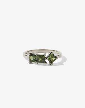 Meadowlark Jewellery’s modern Imogen Engagement Ring in 9ct White Gold, claw set with three princess cut green sapphires. Atop a fine square band. Fully traceable and ethically sourced blue and green sapphires from Queensland, Australia. A graphic 3 stone engagement ring, inspired by art and architecture, this Ceremonial design is made to order in New Zealand.