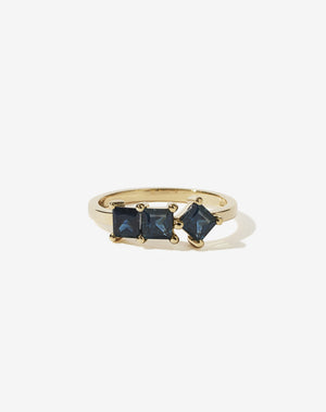 Meadowlark Jewellery’s modern Imogen Engagement Ring in 9ct Yellow Gold, claw set with three princess cut blue sapphires. Atop a fine square band. Fully traceable and ethically sourced blue and green sapphires from Queensland, Australia. A graphic 3 stone engagement ring, inspired by art and architecture, this Ceremonial design is made to order in New Zealand.