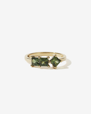 Meadowlark Jewellery’s modern Imogen Engagement Ring in 9ct Yellow Gold, claw set with three princess cut green sapphires. Atop a fine square band. Fully traceable and ethically sourced blue and green sapphires from Queensland, Australia. A graphic 3 stone engagement ring, inspired by art and architecture, this Ceremonial design is made to order in New Zealand.