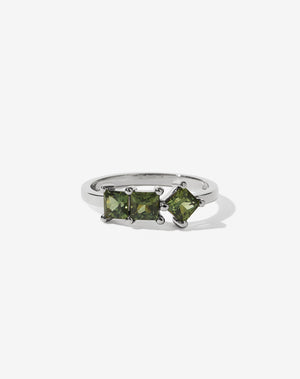 Meadowlark Jewellery’s modern Imogen Engagement Ring in Platinum, claw set with three princess cut green sapphires. Atop a fine square band. Fully traceable and ethically sourced blue and green sapphires from Queensland, Australia. A graphic 3 stone engagement ring, inspired by art and architecture, this Ceremonial design is made to order in New Zealand.