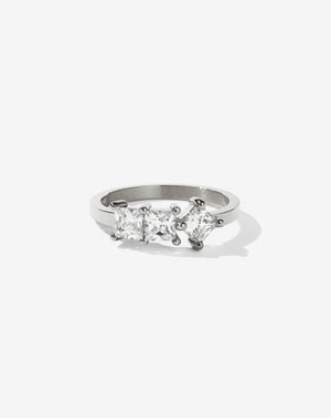 Meadowlark Jewellery’s modern 1.20ct Imogen Engagement Ring in Platinum, claw set with three princess cut white diamonds. Atop a fine square band. A graphic 3 stone engagement ring, inspired by art and architecture, this Ceremonial design is made to order in New Zealand.