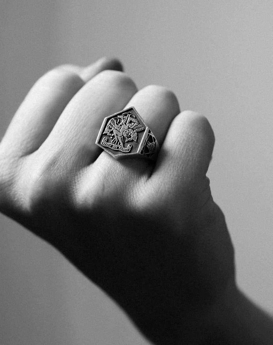 A heavy weighted sterling silver ring with a collage of artworks, designed in collaboration with NZ artist Andrew McLeod. Worn on hand