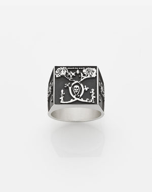A heavy weighted sterling silver ring with a black and white collage artwork design.
