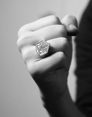 A heavy weighted sterling silver ring with a collage of artworks, designed in collaboration with NZ artist Andrew McLeod. Worn on hand.