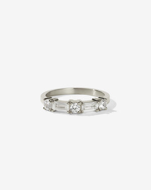 Meadowlark Jewellery’s modern 0.73ct Stella Engagement Ring in 14ct White Gold, claw set with two baguette cut white diamonds and three round brilliant cut white diamonds. Atop a fine square band. A Ceremonial design made to order in New Zealand. Wear as a wedding band with our Hilma Ring or alternative engagement ring.