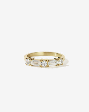 Meadowlark Jewellery’s modern 0.73ct Stella Engagement Ring in 18ct Yellow Gold, claw set with two baguette cut white diamonds and three round brilliant cut white diamonds. Atop a fine square band. A Ceremonial design made to order in New Zealand. Wear as a wedding band with our Hilma Ring or alternative engagement ring.