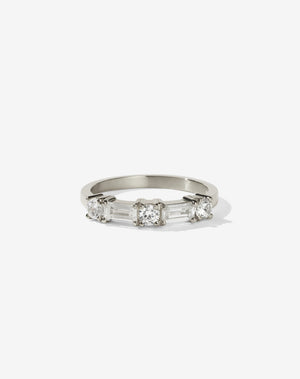 Meadowlark Jewellery’s modern 0.73ct Stella Engagement Ring in 9ct White Gold, claw set with two baguette cut white diamonds and three round brilliant cut white diamonds. Atop a fine square band. A Ceremonial design made to order in New Zealand. Wear as a wedding band with our Hilma Ring or alternative engagement ring.