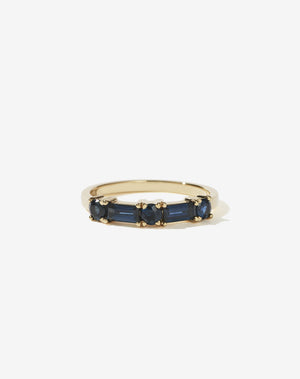 Meadowlark Jewellery’s modern Stella Engagement Ring in 9ct Yellow Gold, claw set with two baguette cut blue sapphires and three round brilliant cut blue sapphires. Atop a fine square band. Fully traceable and ethically sourced blue and green sapphires from Queensland, Australia. A Ceremonial design made to order in New Zealand. Wear as a wedding band with our Hilma Ring or alternative engagement ring.