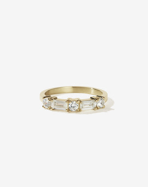 Meadowlark Jewellery’s modern 0.73ct Stella Engagement Ring in 9ct Yellow Gold, claw set with two baguette cut white diamonds and three round brilliant cut white diamonds. Atop a fine square band. A Ceremonial design made to order in New Zealand. Wear as a wedding band with our Hilma Ring or alternative engagement ring.