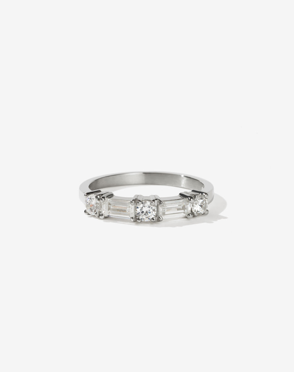 Meadowlark Jewellery’s modern 0.73ct Stella Engagement Ring in Platinum, claw set with two baguette cut white diamonds and three round brilliant cut white diamonds. Atop a fine square band. A Ceremonial design made to order in New Zealand. Wear as a wedding band with our Hilma Ring or alternative engagement ring.