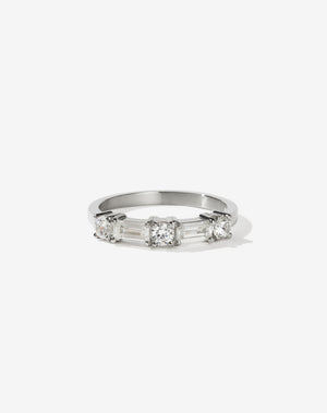 Meadowlark Jewellery’s modern 0.73ct Stella Engagement Ring in Platinum, claw set with two baguette cut white diamonds and three round brilliant cut white diamonds. Atop a fine square band. A Ceremonial design made to order in New Zealand. Wear as a wedding band with our Hilma Ring or alternative engagement ring.