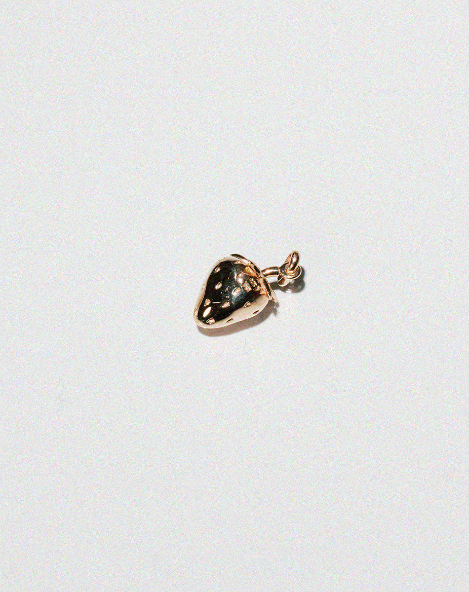 Gold charm in the shape of a cute strawberry