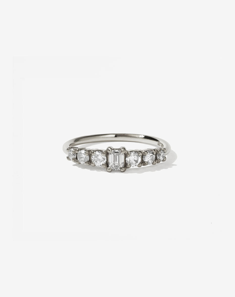 Meadowlark Jewellery’s beautiful Amelie Engagement Ring in 14ct White Gold, claw set with 0.70ct emerald cut and round brilliant cut white diamonds atop a fine round band. A low set, petite seven stone engagement ring this Ceremonial design made to order in New Zealand.