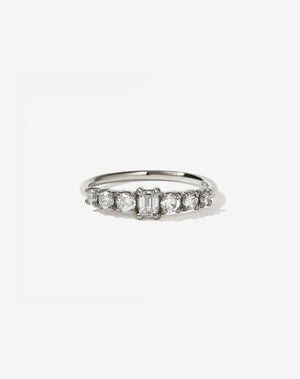 This beautiful and petite seven stone ring has a central emerald cut stone and is flanked by three ascending sized round brilliant diamonds on each shoulder.</p>