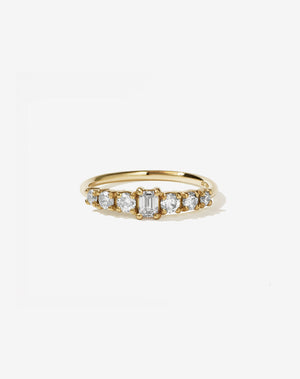 Meadowlark Jewellery’s beautiful Amelie Engagement Ring in 18ct Yellow Gold, claw set with 0.70ct emerald cut and round brilliant cut white diamonds atop a fine round band. A low set, petite seven stone engagement ring this Ceremonial design made to order in New Zealand.