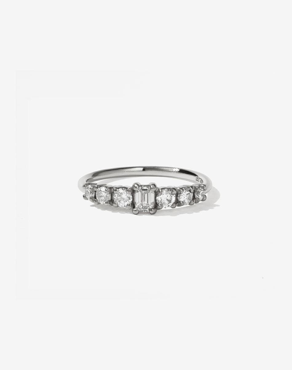 Meadowlark Jewellery’s beautiful Amelie Engagement Ring in Platinum, claw set with 0.70ct emerald cut and round brilliant cut white diamonds atop a fine round band. A low set, petite seven stone engagement ring this Ceremonial design made to order in New Zealand.