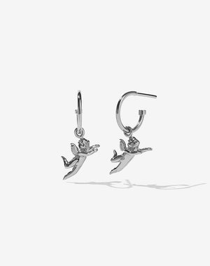 A pair of sterling silver hoop earrings with a cherub charm hanging from them.